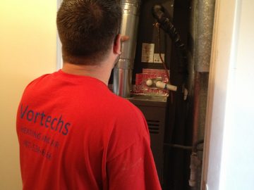 Vortechs Heating and Air Employee Fixing Furnace in Winter Park